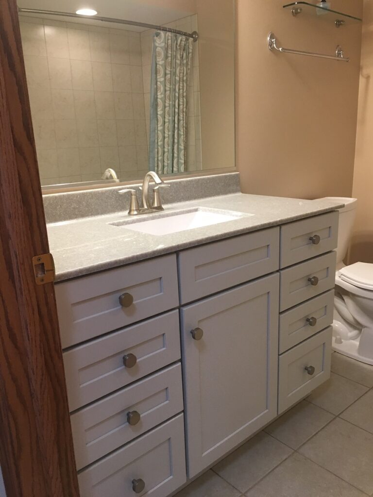 Bathroom with white vanity and mirror.