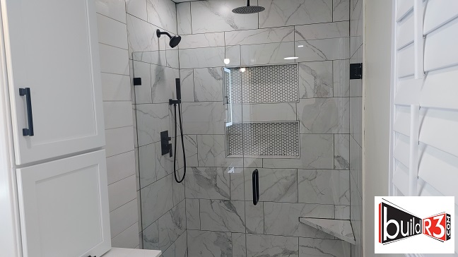 Modern tiled shower with rainfall showerhead.