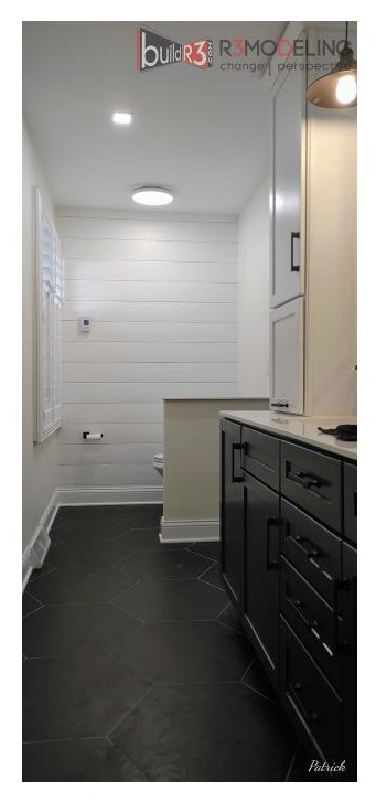 Modern bathroom with dark cabinetry and flooring.