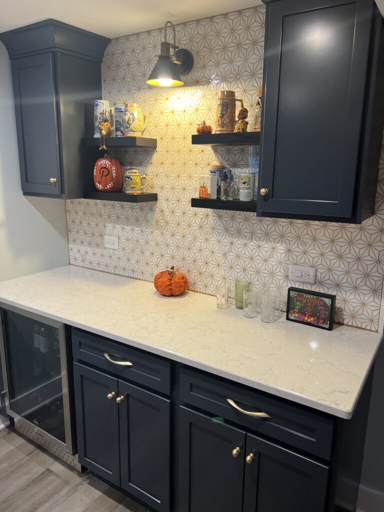 Kitchen counter with dark cabinets and shelves.